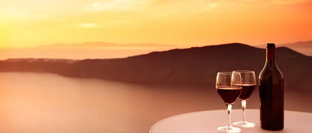 Wine bottle and wine glasses in the sunset